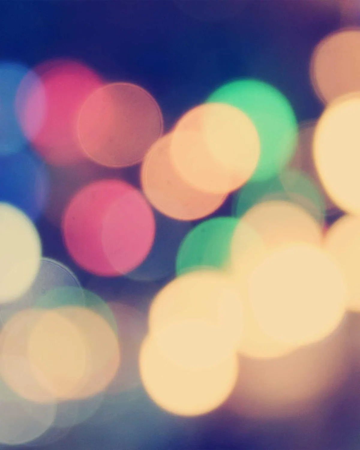 Out-of-focus string lights in warm and cool colours at an evening event